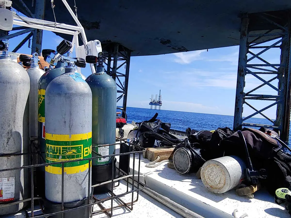 NAUI dive tanks on the Diver I with jack-up rig in the background